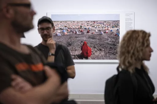 Jonathan Fointaine's "The Nomad's Final Journey", which was awarded with an honorable mention by the World Press Photo jury, is on display at the opening of the World Press Photo 2023 exhibition at the Hungarian National Museum, in Budapest, Hungary, Thursday, Sept. 21, 2023. Minors under 18 have been barred from visiting this year’s World Press Photo exhibition in Hungary after the government determined that some of its photos violate a contentious law restricting LGBTQ+ content. (Szigetvary 