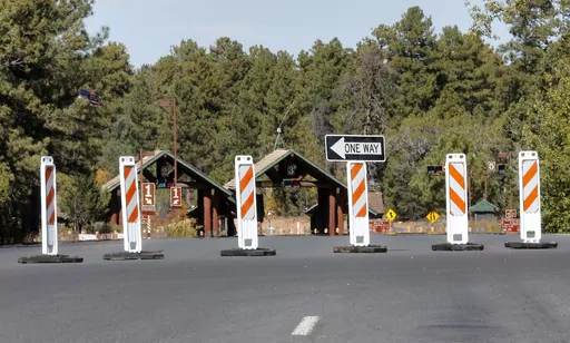 The Grand Canyon National Park entrance is blocked off, in Tusayan, Ariz., Oct. 8, 2013, because of a partial government shutdown. Arizona's Grand Canyon National Park and all five national parks in Utah will remain open if the U.S. government shuts down, Sunday, Oct. 1, 2023. Arizona Gov. Katie Hobbs and Utah Gov. Spencer Cox say that the parks are important destinations and local communities depend on dollars from visitors. (AP Photo/Matt York, File)