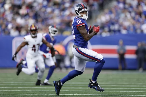 New York Giants tight end Darren Waller (12) makes a catch against the Washington Commanders during the first quarter of an NFL football game, Oct. 22, 2023, in East Rutherford, N.J. The Giants activated Waller from injured reserve and waived veteran safety Bobby McCain on Saturday, Dec. 16. (AP Photo/Adam Hunger, File)
