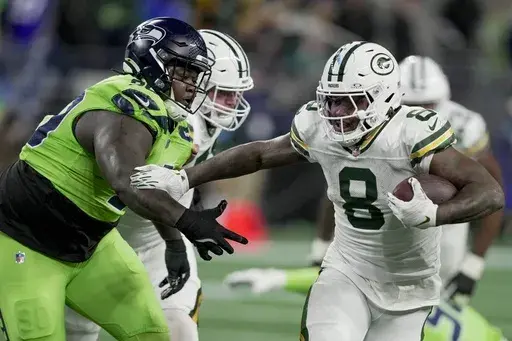 Green Bay Packers' Josh Jacobs runs for a first down during the first half of an NFL football game against the Seattle Seahawks Sunday, Dec. 15, 2024, in Seattle. (AP Photo/Stephen Brashear)