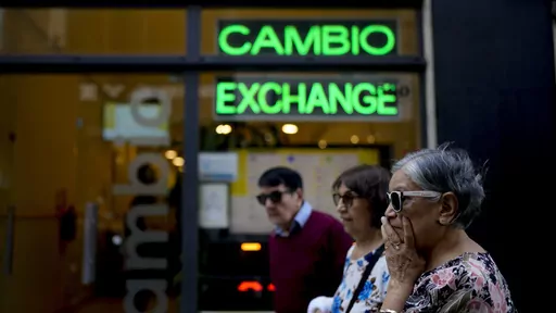 Pedestrians walk past a money exchange shop in Buenos Aires, Argentina, Oct. 10, 2023. Argentina's new economy minister said in a televised message on Tuesday, Dec. 12, the Argentine peso will be devalued by 50% from 400 to the U.S. dollar to 800 pesos to the dollar (AP Photo/Natacha Pisarenko, File)