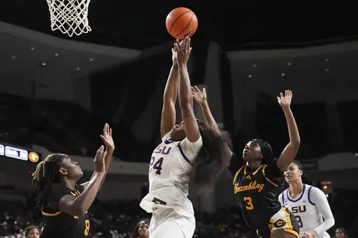 LSU guard Aneesah Morrow (24) goes to the basket between Grambling guard Arianna Mosley (3) and forward Alyssa Phillip (8) in the second half an NCAA college basketball game in Bossier City, La., Sunday, Dec. 8, 2024. LSU won 100-54. (AP Photo/Gerald Herbert)