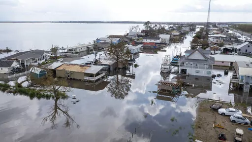 In this aerial photo taken with a drone, flood waters surround storm damaged homes on Aug. 31, 2021, in Lafourche Parish, La., as residents try to recover from the effects of Hurricane Ida. Ten Filipino men who worked for a major offshore oil industry employer claim in a federal lawsuit in Feburary 2022 that they were treated like prisoners at a company bunkhouse — and that two of them were abandoned there when Hurricane Ida struck the Louisiana Gulf Coast in 2021. (AP Photo/Steve Helber, File