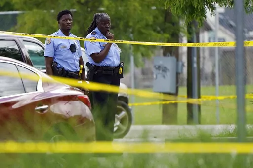 Investigators search the crime scene of a shooting at Xavier University in New Orleans, Tuesday, May 31, 2022.  (AP Photo/Gerald Herbert)