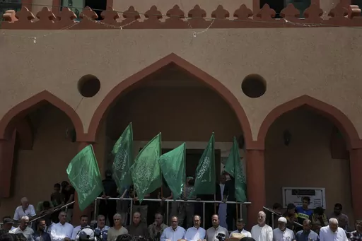 Hamas supporters and masked militants from the Izzedine al-Qassam Brigades, the military wing of Hamas, wave the green flags of the Islamist group during a protest in support of Palestinian prisoners in Israeli jails, after Friday prayer in Nusseirat refugee camp, central Gaza Strip, Friday, Aug. 18, 2023. It has become an Israeli mantra throughout the latest war in Gaza: Hamas is ISIS. Since the bloody Hamas attack on Oct. 7 that triggered the war, Israeli leaders and commanders have likened th