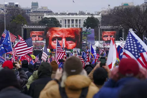 In this Jan. 6, 2021 file photo, Trump supporters participate in a rally in Washington. On Friday, Oct. 21, 2022, The Associated Press reported on stories circulating online incorrectly claiming that former President Donald Trump signed an order to deploy 20,000 National Guard troops before his supporters stormed the U.S. Capitol on Jan. 6, 2021, but was stopped by the House sergeant at arms, at the behest of Speaker Nancy Pelosi.  (AP Photo/John Minchillo, FIle)