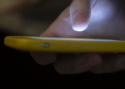 A man uses a cell phone in New Orleans on Aug. 11, 2019. Some social media users are calling out celebrities for what they say is inaction in the face of a humanitarian crisis in Gaza — and they've taken to a "blockout" to pressure the stars to take a stand. For the blockout, users put a block on seeing any and all content from the accounts of certain celebrities on social media platforms including X, TikTok and Instagram. (AP Photo/Jenny Kane, File)
