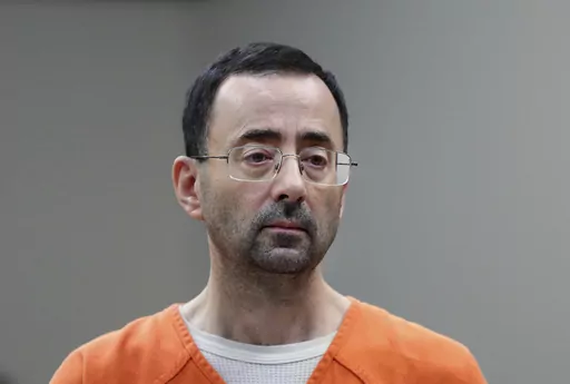 Dr. Larry Nassar, 54, appears in court for a plea hearing in Lansing, Mich., on Nov. 22, 2017. Recent assaults on two notorious, high-profile federal prisoners have renewed concerns about whether the federal Bureau of Prisons is capable of keeping people in its custody safe. Nassar was knifed repeatedly in his cell at a federal penitentiary in Florida in July. (AP Photo/Paul Sancya, File)