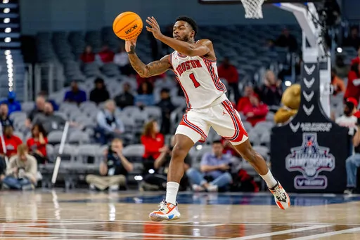 Houston guard Jamal Shead (1) passes the ball down the court in the first half of an NCAA college basketball game against Tulane in the semifinals of the American Athletic Conference tournament in Fort Worth, Texas, Saturday, March 12, 2022. (AP Photo/Gareth Patterson)