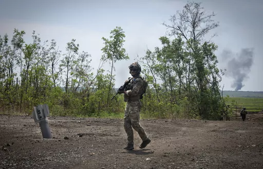 Ukrainian soldiers walk in their positions on the frontline in Zaporizhzhia region, Ukraine, Friday, June 23, 2023. In the southeastern Zaporizhzhia region, Ukrainian troops - backed by tanks, artillery and drones - have broken through initial Russian fighting positions and continue to make steady gains south of Velyka Novosilka near the administrative border with Donestk and south of Orikhiv, while confronting heavy bombardment in wide open fields with little cover. (AP Photo/Efrem Lukatsky, Fi