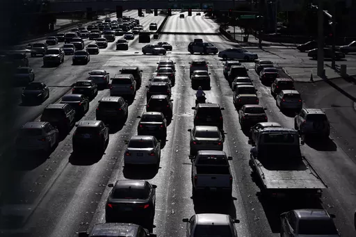 Cars wait at a red light during rush hour, April 22, 2021, in Las Vegas. Motor vehicles with higher, more vertical front ends are the most dangerous to pedestrians, according to a highway safety organization. (AP Photo/John Locher, File)