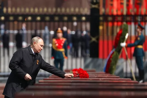 Russian President Vladimir Putin attends a wreath-laying ceremony at the Tomb of the Unknown Soldier after the military parade marking the 77th anniversary of the end of World War II in Moscow, Russia, Monday, May 9, 2022. (Anton Novoderezhkin, Sputnik, Kremlin Pool Photo via AP)