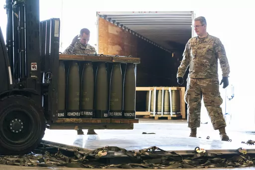 Airmen with the 436th Aerial Port Squadron place 155 mm shells on aircraft pallets ultimately bound for Ukraine, April 29, 2022, at Dover Air Force Base, Del. Half of the people in the U.S. support the Pentagon's ongoing supply of weapons to Ukraine for its defense against Russian forces. That's according to a new survey by the University of Chicago's Harris School of Public Policy and NORC. (AP Photo/Alex Brandon, File)