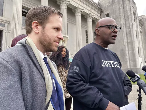 Attorney Richard Davis, left, of the Innocence Project New Orleans, stands next to Raymond Flanks outside the New Orleans criminal courthouse on Thursday, Nov. 17, 2022. A judge vacated Flanks' conviction in a 1983 murder and set him free, ending his nearly four decades in prison, after prosecutors and defense lawyers agreed that evidence favorable to him was withheld from his attorneys in the 1980s. (AP Photo/Kevin McGill)