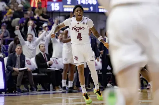 Texas A&M guard Wade Taylor IV (4) reacts after a three-point basket against LSU during the first half of an NCAA college basketball game in Baton Rouge, La., Saturday, March 8, 2025. (AP Photo/Matthew Hinton)