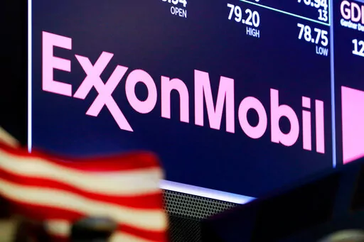 The logo for ExxonMobil appears above a trading post on the floor of the New York Stock Exchange on April 23, 2018. The U.S. government said in a lawsuit filed Thursday, March 2, that ExxonMobil Corp. violated federal law for failing to take sufficient action after five hangman’s nooses were displayed at its facility in Baton Rouge, La. (AP Photo/Richard Drew, File)