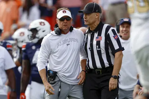 Auburn head coach Hugh Freeze talks with a referee after a play in the second half of an NCAA college football game against Vanderbilt, Saturday, Nov. 2, 2024, in Auburn, Ala. (AP Photo/ Butch Dill)