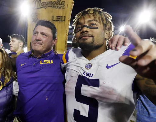 LSU head coach Ed Orgeron, left, celebrates with running back Derrius Guice (5) following a win over Mississippi in an NCAA college football game Oct. 21, 2017, in Oxford, Miss. LSU and 10 former students who sued the school over alleged mishandling of sexual assault and domestic violence complaints against football players and others at Louisiana’s flagship state university have settled the case, a judge wrote in a March 28, 2024, order. Four of the the plaintiffs in the 2021 civil case accus