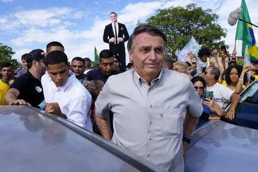 Brazil's President Jair Bolsonaro campaigns at the rural workers' settlement Nova Jerusalem, or New Jerusalem, in Brasilia, Brazil, Monday, Oct. 24, 2022. Bolsonaro is running for reelection in the presidential runoff set for Oct. 30. (AP Photo/Eraldo Peres)