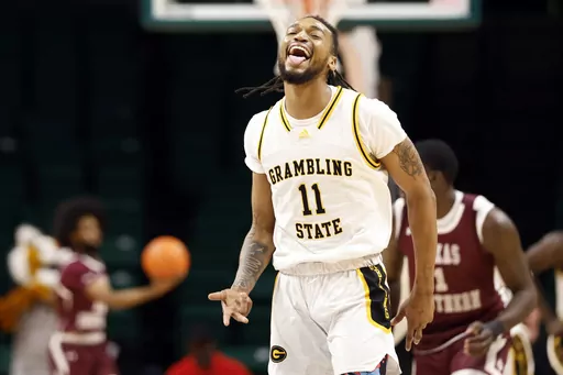 Grambling State guard Jourdan Smith (11) reacts after making a 3-point basket during the first half of an NCAA college basketball game against Texas Southern in the championship of the Southwestern Athletic Conference tournament, Saturday, March 16, 2024, in Birmingham, Ala. (AP Photo/Butch Dill)