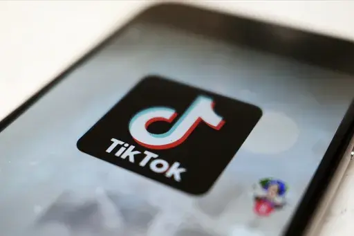 The TikTok logo is displayed on a smartphone screen in Tokyo on Sept. 28, 2020. TikTok says it's going to start automatically labeling content that's made by artificial intelligence when it's uploaded from certain platforms. TikTok says its efforts are an attempt to combat misinformation from being spread on its social media platform. The announcement came on ABC's “Good Morning America” on Thursday, May 9, 2024. (AP Photo/Kiichiro Sato, File)