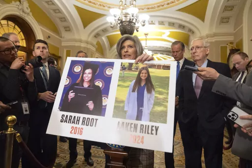 Sen. Joni Ernst, R-Iowa, holds a poster with photos of murder victims Sarah Root and Laken Riley as she speaks on Capitol Hill, Feb. 27, 2024, in Washington. House Republicans have passed a bill that would require federal authorities to detain unauthorized immigrants who have been accused of theft, seizing on the recent death of Laken, a nursing student in Georgia. The bill sends a rebuke to President Joe Biden’s border policies just hours ahead of his State of the Union address. However, the 