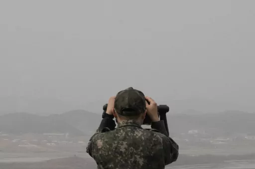 A South Korean army soldier watches the North Korea side from the Unification Observation Post in Paju, South Korea, near the border with North Korea, Friday, March 24, 2023. North Korea said Friday its cruise missile launches this week were part of nuclear attack simulations that also involved a detonation by a purported underwater drone as leader Kim Jong Un vowed to make his rivals "plunge into despair." (AP Photo/Ahn Young-joon)