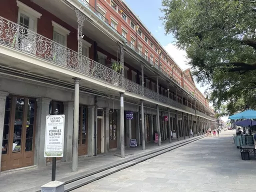 A view of the Upper Pontalba building in New Orleans' French Quarter on July 19, 2023. The building hosts businesses on the ground floor and coveted apartments on its upper floors. One of the apartments has been traditionally used by city mayors for meetings, special events or visiting dignitaries but the City Council –overriding a veto by Mayor LaToya Cantrell—has voted to put the apartment back into commerce following months of controversy over Cantrell’s use of the space. (AP Photo/Kevi