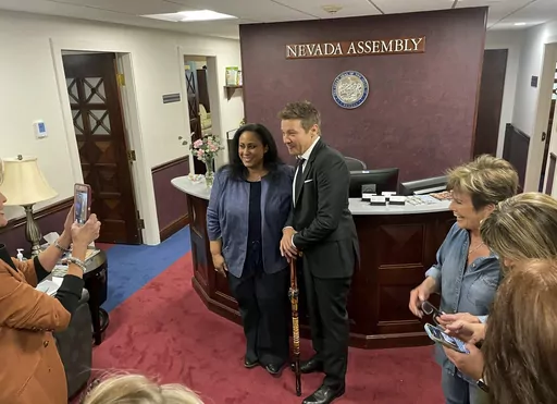 Actor Jeremy Renner poses for a photo with Democratic Assemblywoman Brittney Miller in Carson City, Nev., on Monday, May 22, 2023. Renner spent Monday pitching an amendment to Nevada lawmakers to include his home region in a tax deal to expand the film industry to Las Vegas. But his hopes of making northern Nevada a film hub are likely on hold after the bill sponsor said it's too late to add his project. (AP Photo/Gabe Stern)
