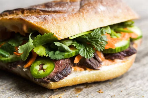 This image released by Milk Street shows a recipe for Vietnamese Skirt Steak Sandwiches. (Milk Street via AP)