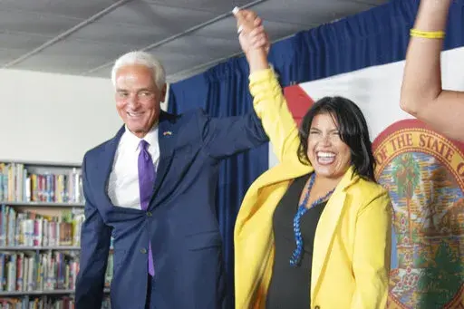 U.S. Rep. Charlie Crist celebrates as he announces his running mate Karla Hernández-Mats at Hialeah Middle School in Hialeah, Fla., Saturday Aug. 27, 2022 as he challenges Republican Gov. Ron DeSantis in November (AP Photo/Gaston De Cardenas)