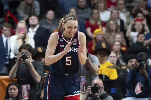 UConn guard Paige Bueckers reacts after a game against Southern California in the Elite Eight of the NCAA college basketball tournament Monday, March 31, 2025, in Spokane, Wash. (AP Photo/Jenny Kane)