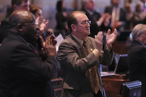 Louisiana state Reps. A.B. Franklin, D-Lake Charles, and Jack Montoucet, D-Crowley, applaud Gov. Bobby Jindal following his speech during the opening of the state Legislature at the state Capitol in Baton Rouge, La., March 10, 2014. Montoucet, now the secretary of Louisiana's Department of Wildlife and Fisheries, resigned Friday, April 14, 2023, amid a developing scandal that saw a former member of the state wildlife commission plead guilty to a federal bribery charge. (AP Photo/Hilary Scheinuk,