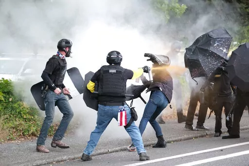 Members of the far-right group Proud Boys and anti-fascist protesters spray bear mace at each other during clashes between the politically opposed groups in Portland, Ore., Aug. 22, 2021. Over the past decade, Oregon experienced the sixth-highest number of extremist incidents in the nation, despite being 27th in population, according to an Oregon Secretary of State report. Now, the state Legislature is considering a bill that, experts say, would create the nation's most comprehensive law against