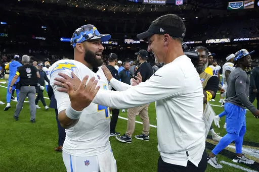 Los Angeles Chargers quarterback Chase Daniel greets New Orleans Saints head coach Dennis Allen, right, after a preseason NFL football game in New Orleans, Friday, Aug. 26, 2022. The Saints won 27-10. (AP Photo/Gerald Herbert)