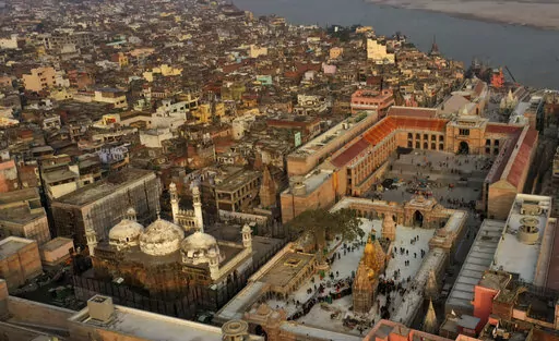 An Aerial view shows Gyanvapi mosque, left, and Kashiviswanath temple on the banks of the river Ganges in Varanasi, India, Dec. 12, 2021. A group of Hindus petitioned a local court seeking access to pray inside the mosque compound, saying they believe the Gyanvapi mosque in Varanasi, one of Hinduism’s holiest cities, was built on top of the ruins of a medieval-era temple and that the complex still houses Hindu idols and motifs, a claim that has been contested by the mosque authorities. (AP Pho