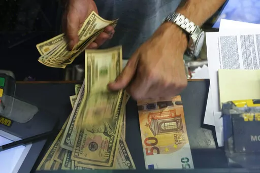A cashier changes a 50 Euro banknote with US dollars at an exchange counter in Rome, Wednesday, July 13, 2022. Inflation for the European countries using the euro currency hit another record in August, fuelled by soaring energy prices mainly driven by Russia’s war in Ukraine. Annual inflation in the eurozone’s 19 countries rose to 9.1% in August, up from 8.9% recorded in July. That's according to the latest figures released Wednesday, Aug. 31, 2022 by the European Union statistics agency. (A
