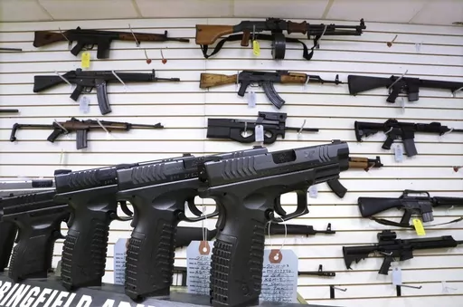 Semi-automatic guns are displayed for sale at Capitol City Arms Supply, Jan. 16, 2013, in Springfield, Ill. Illinois will soon outlaw advertising for firearms that officials determine produces a public safety threat or appeals to children, militants or others who might later use them illegally, as the state continues its quest to curb mass shootings. (AP Photo/Seth Perlman, File)