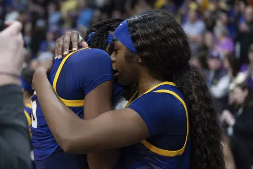 LSU forward Aneesah Morrow, right, hugs LSU forward Sa'Myah Smith after a game against UCLA in the Elite Eight of the NCAA college basketball tournament, Sunday, March 30, 2025, in Spokane, Wash. (AP Photo/Jenny Kane)