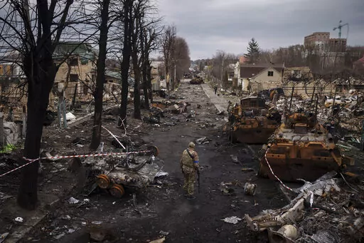 A Ukrainian serviceman walks amid destroyed Russian tanks in Bucha, on the outskirts of Kyiv, Ukraine, April 6, 2022. Russia is bracing up for a massive new offensive in eastern Ukraine, hoping to reverse its fortunes on the battlefield after a catastrophic start of the invasion. (AP Photo/Felipe Dana, File)