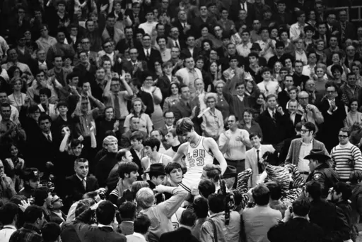 THIS CORRECTS THE DATE TO JAN. 31, 1970, NOT JAN. 28, 1979, AS ORIGINALLY SENT - - FILE - Pete Maravich (23) gets a boost from players and fans after he broke the all-time scoring record in Baton Rouge, La., Jan. 31, 1970. Calmly looking on at far left center is Pete's dad, Press, who coaches the Louisiana State Tigers. Those who played with, followed or knew the late Maravich are conflicted about the seemingly inevitable moment — likely this Sunday — when he could be supplanted by Iowa wome