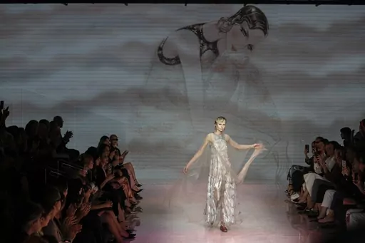 A model wears a creation as part of the Giorgio Armani women's Spring Summer 2024 collection presented in Milan, Italy, Sunday, Sept. 24, 2023. (AP Photo/Luca Bruno)