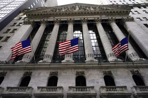 American flags fly outside the New York Stock exchange, Friday, Jan. 14, 2022, in the Financial District in New York. Stocks are off to a weak start on Wall Street, Thursday, Feb. 17, chipping away at the weekly gains for major indexes.  (AP Photo/Mary Altaffer, File)