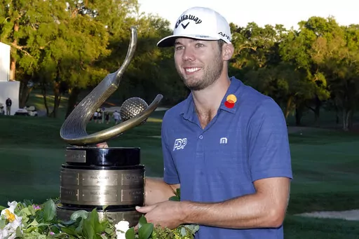 Sam Burns poses with the trophy after winning the Valspar Championship golf tournament Sunday, March 20, 2022, at Innisbrook in Palm Harbor, Fla. (AP Photo/Chris O'Meara)