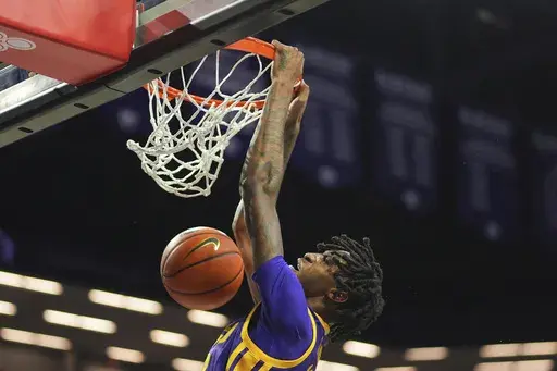 LSU forward Daimion Collins dunks the ball during the first half of an NCAA college basketball game against Kansas State Thursday, Nov. 14, 2024, in Manhattan, Kan. (AP Photo/Charlie Riedel)