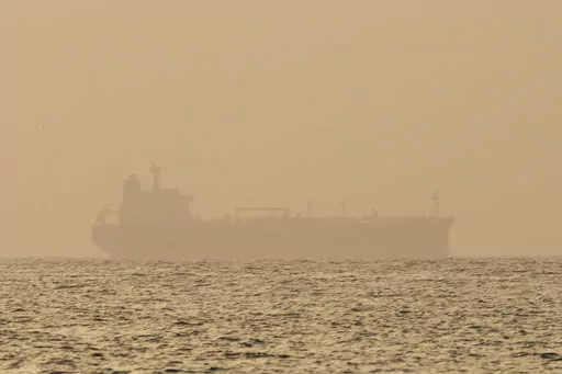 An oil tanker is moored off Fujairah, United Arab Emirates, Wednesday, Aug. 4, 2021. Technology to hide a ship's location previously available only to the world's militaries is spreading fast through the global maritime industry as governments from Iran to Venezuela — and the rogue shipping companies they depend on to move their petroleum products — look for stealthier ways to circumvent U.S. sanctions. (AP Photo/Jon Gambrell)