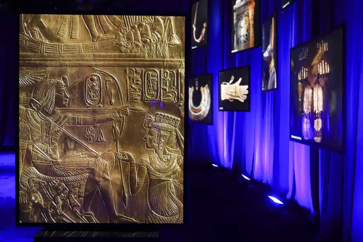Photos of artifacts found in King Tut's tomb are displayed at the King Tut Immersive Experience, Thursday, Oct. 27, 2022, in New York. The exhibition will open to the public on Friday, in commemoration of the the 100th anniversary of the discovery of King Tut's tomb on Nov. 4, 1922. (AP Photo/Julia Nikhinson)