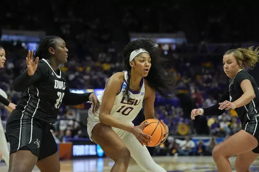 LSU forward Angel Reese (10) looks to pass against Rice center Sussy Ngulefac, left, during the first half of a first-round college basketball game in the women's NCAA Tournament in Baton Rouge, La., Friday, March 22, 2024. (AP Photo/Gerald Herbert)