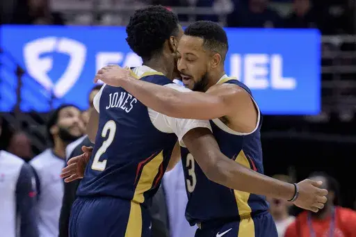 New Orleans Pelicans guard CJ McCollum (3) celebrates a 3-point basket with forward Herbert Jones (2) during the first half of an NBA basketball game against the Washington Wizards in New Orleans, Friday, Jan. 3, 2025. (AP Photo/Matthew Hinton)