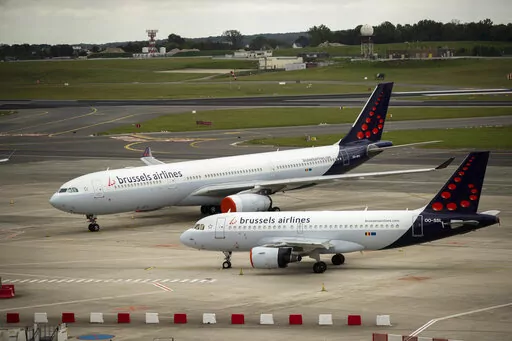 In this Tuesday, May 12, 2020 file photo, planes from Brussels Airlines on the tarmac at Brussels Airport in Brussels Tuesday, May 12, 2020. The European Union's airspace is filling up again with near-empty flights in pandemic times that even airlines admit serve no commercial purpose except securing valuable slots in some of the world's biggest airports. (AP Photo/Francisco Seco, File)